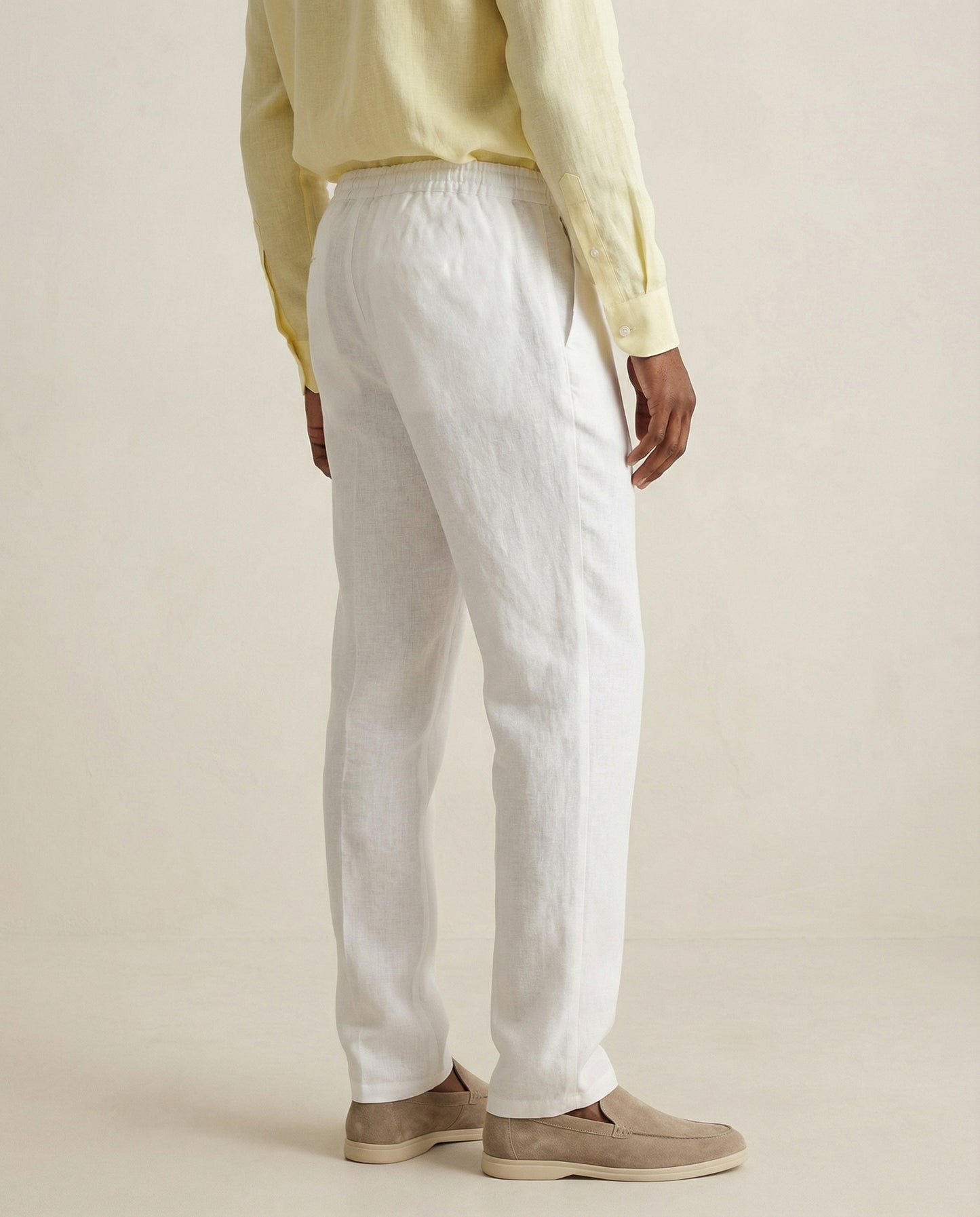 Back view of men’s pearl white linen trousers with elastic waistband