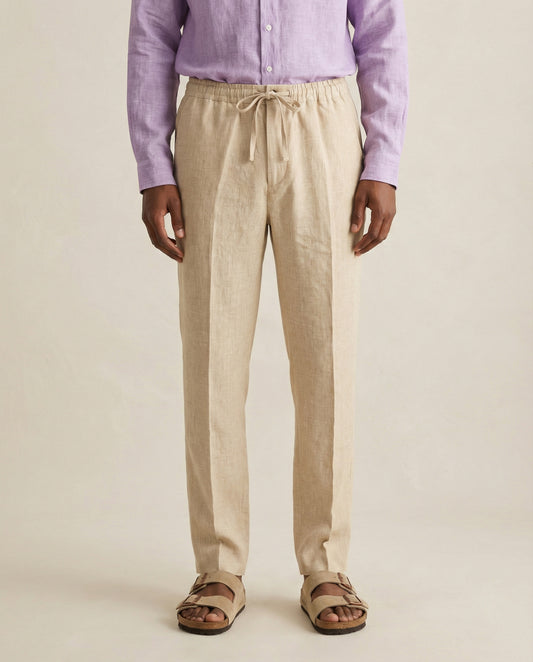 Front view of men’s beige linen trousers with drawstring waist
