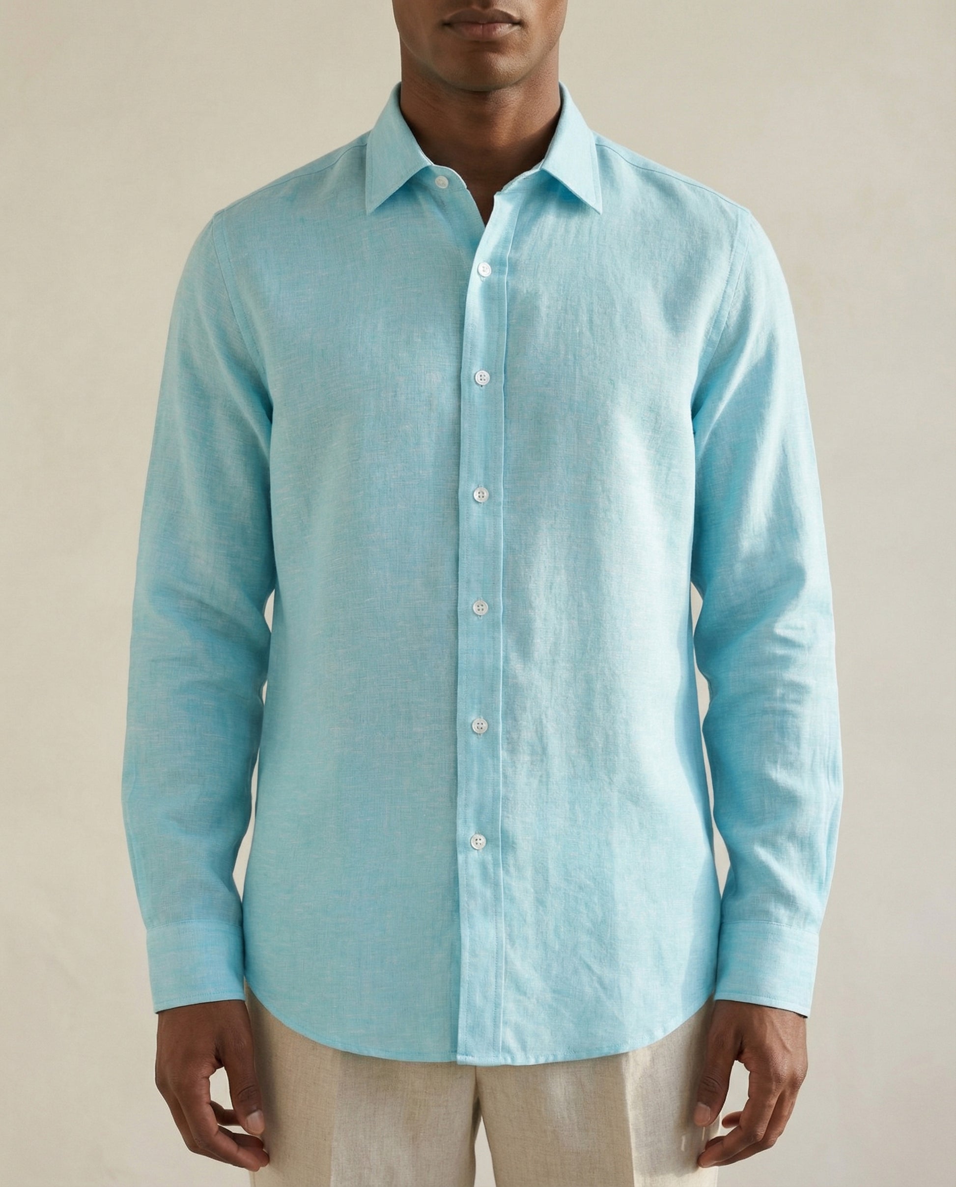 Close-up detail of turquoise linen shirt showing natural linen texture