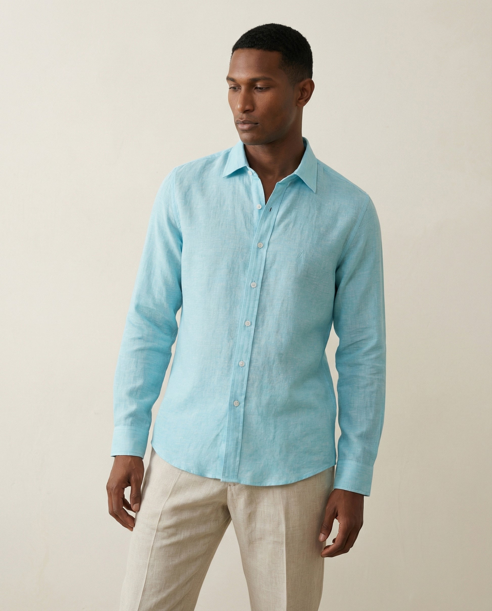 Mid-length view of men’s turquoise linen shirt with relaxed tailoring