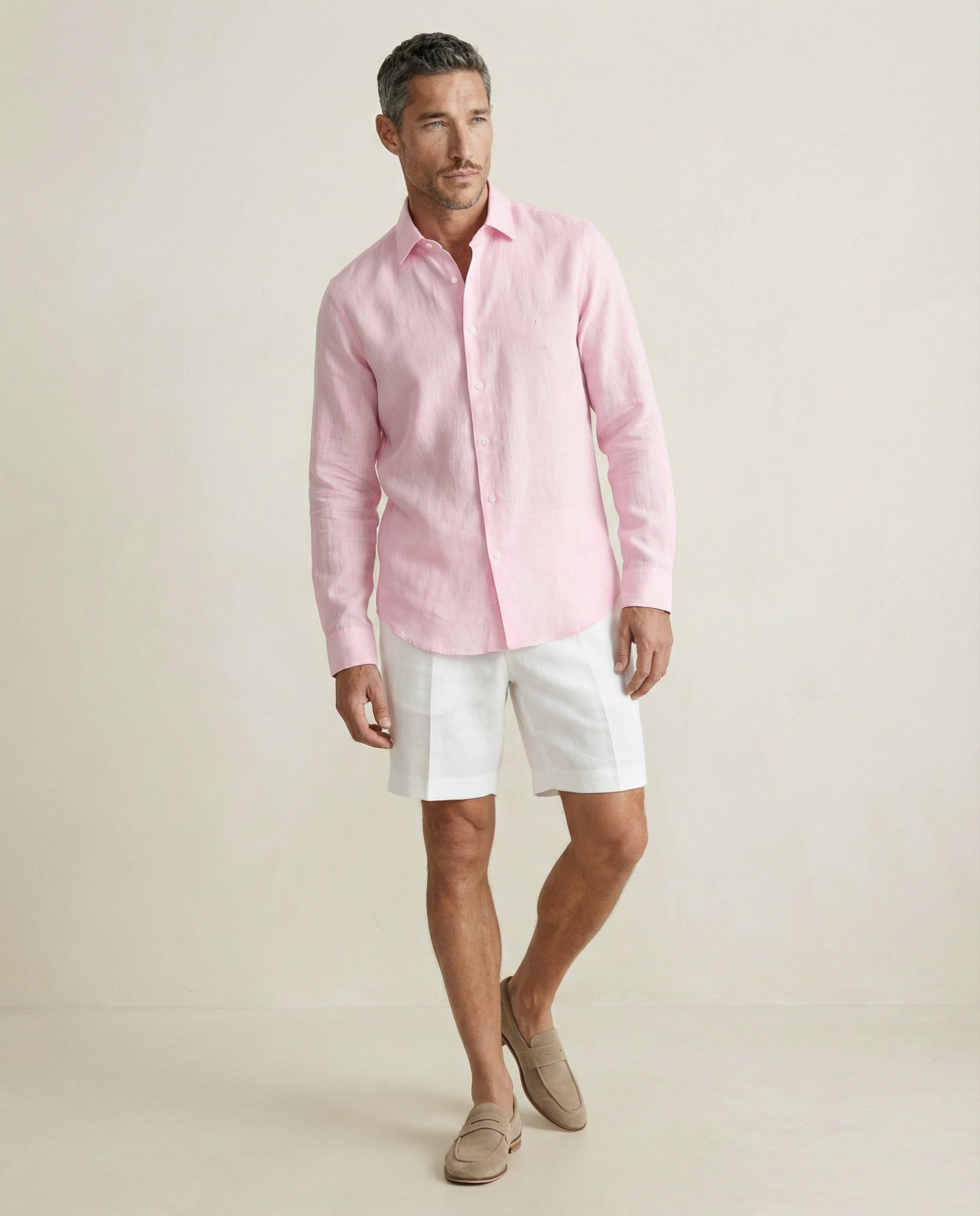 Men wearing coral baby pink linen shirt styled with white shorts