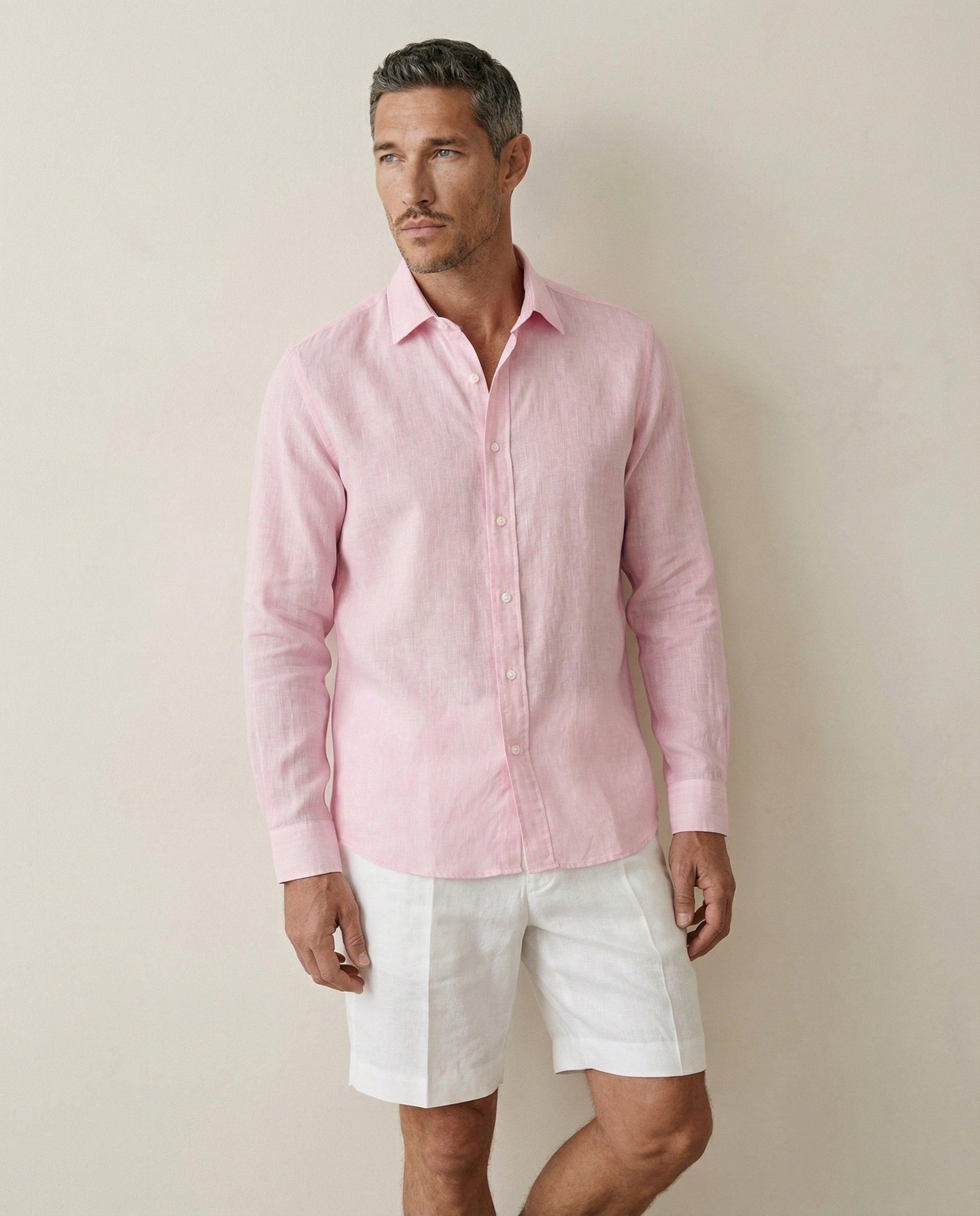 Mid view of men’s coral baby pink linen shirt showing fit and drape