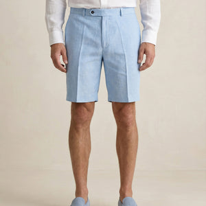 Detail of light blue linen shorts fabric and tailored waistband