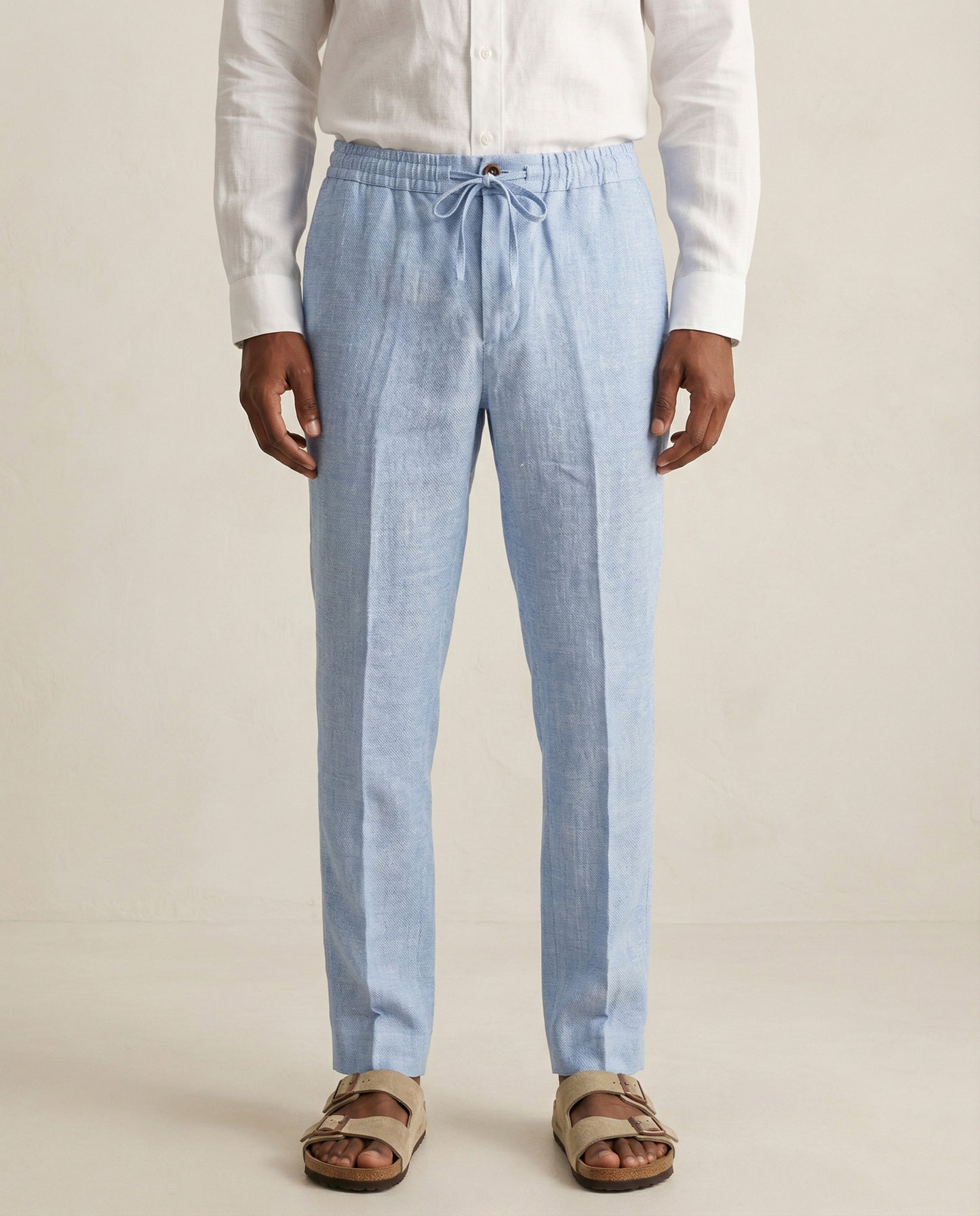 Front view of men’s light blue linen trousers