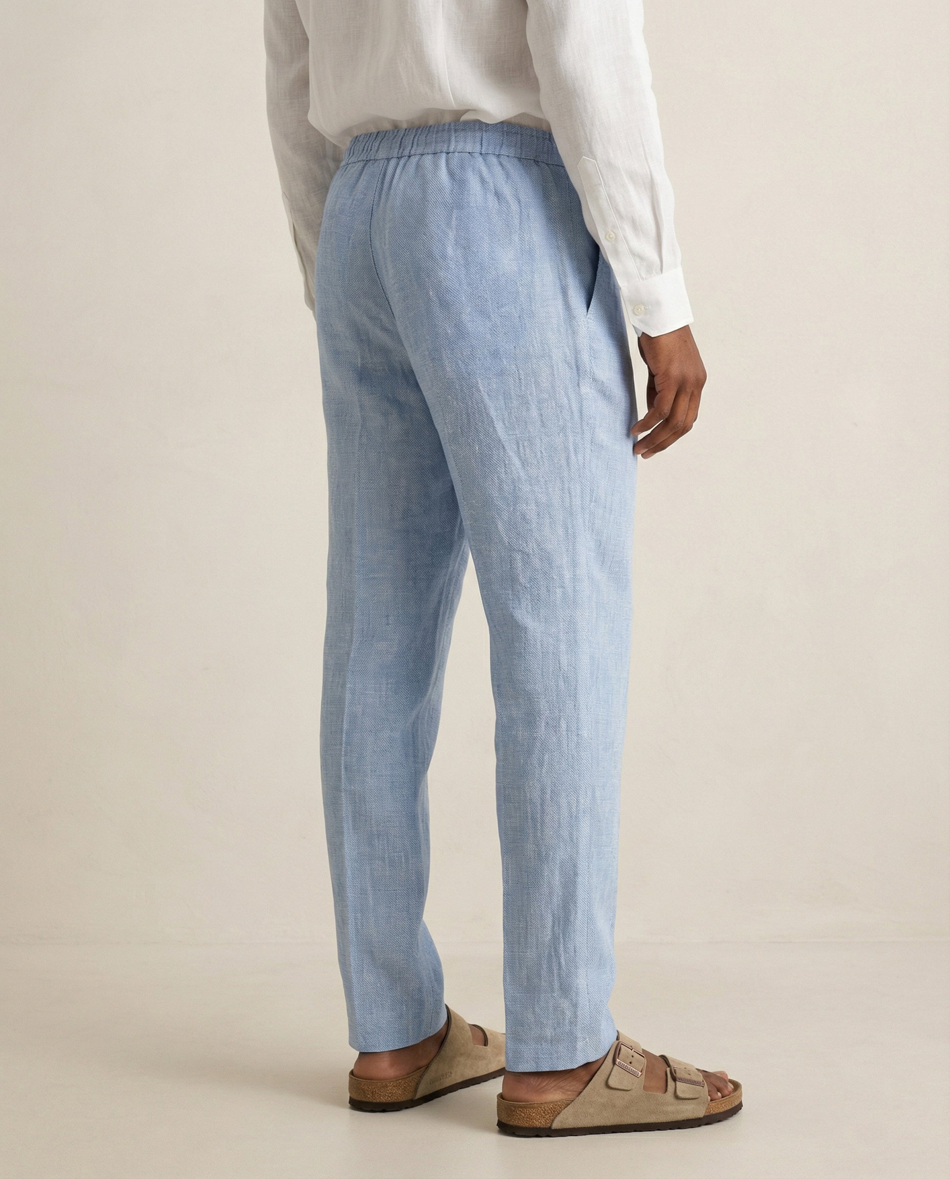 Back view of men’s light blue linen trousers