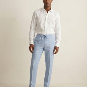 Men wearing light blue linen trousers styled for summer
