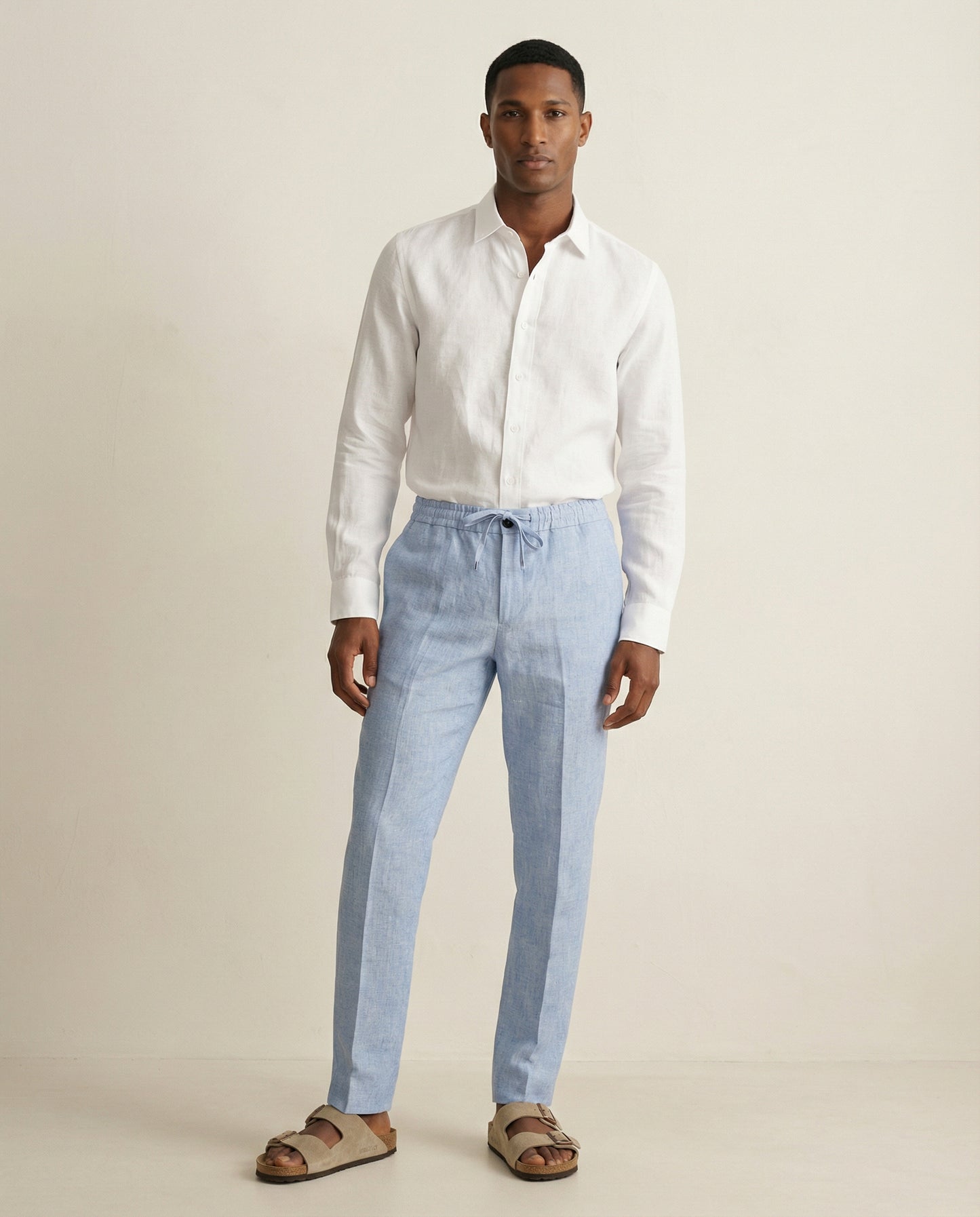 Men wearing light blue linen trousers styled for summer