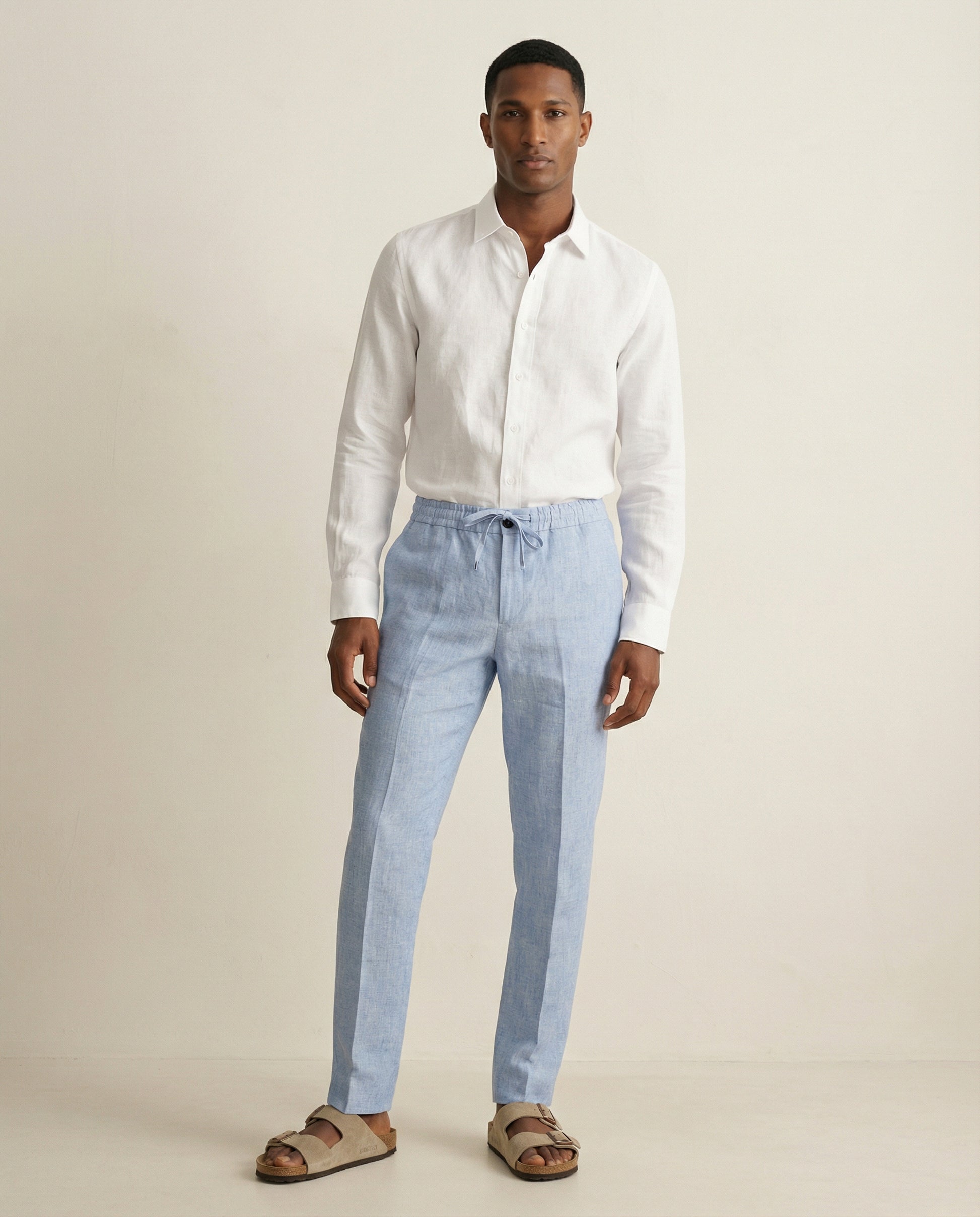 Men wearing light blue linen trousers styled for summer