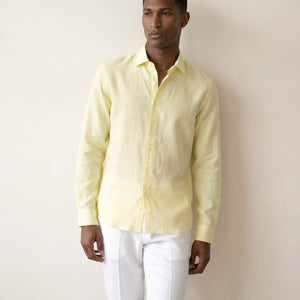 Light yellow linen shirt worn by model showing relaxed tailored fit