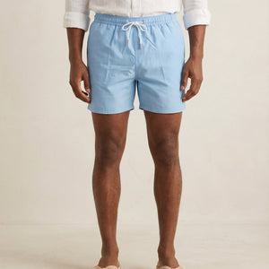 Lumari light blue swim shorts front product view on model.