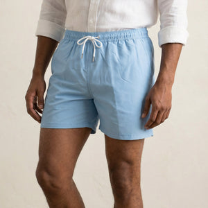 Close-up detail of Lumari light blue swim shorts with elastic waistband and drawstring.