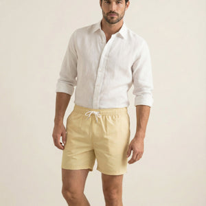 Lumari light yellow swim shorts with elastic waistband and drawstring, mid-length fit.