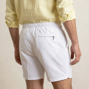 Back view of Lumari white swim shorts featuring welt back pocket.