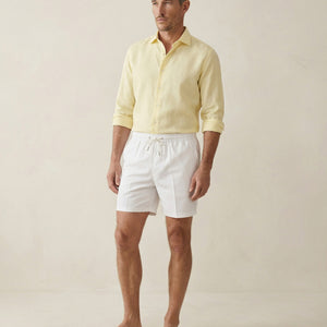 Apprivió Lumari white swim shorts styled with linen shirt, full body view