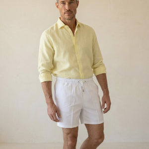Lumari white swim shorts mid-body view showing elastic waistband and tailored silhouette.