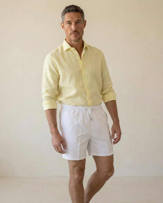 Lumari white swim shorts mid-body view showing elastic waistband and tailored silhouette.