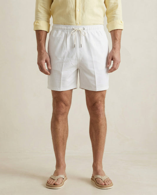 Lumari white swim shorts front product view on model.