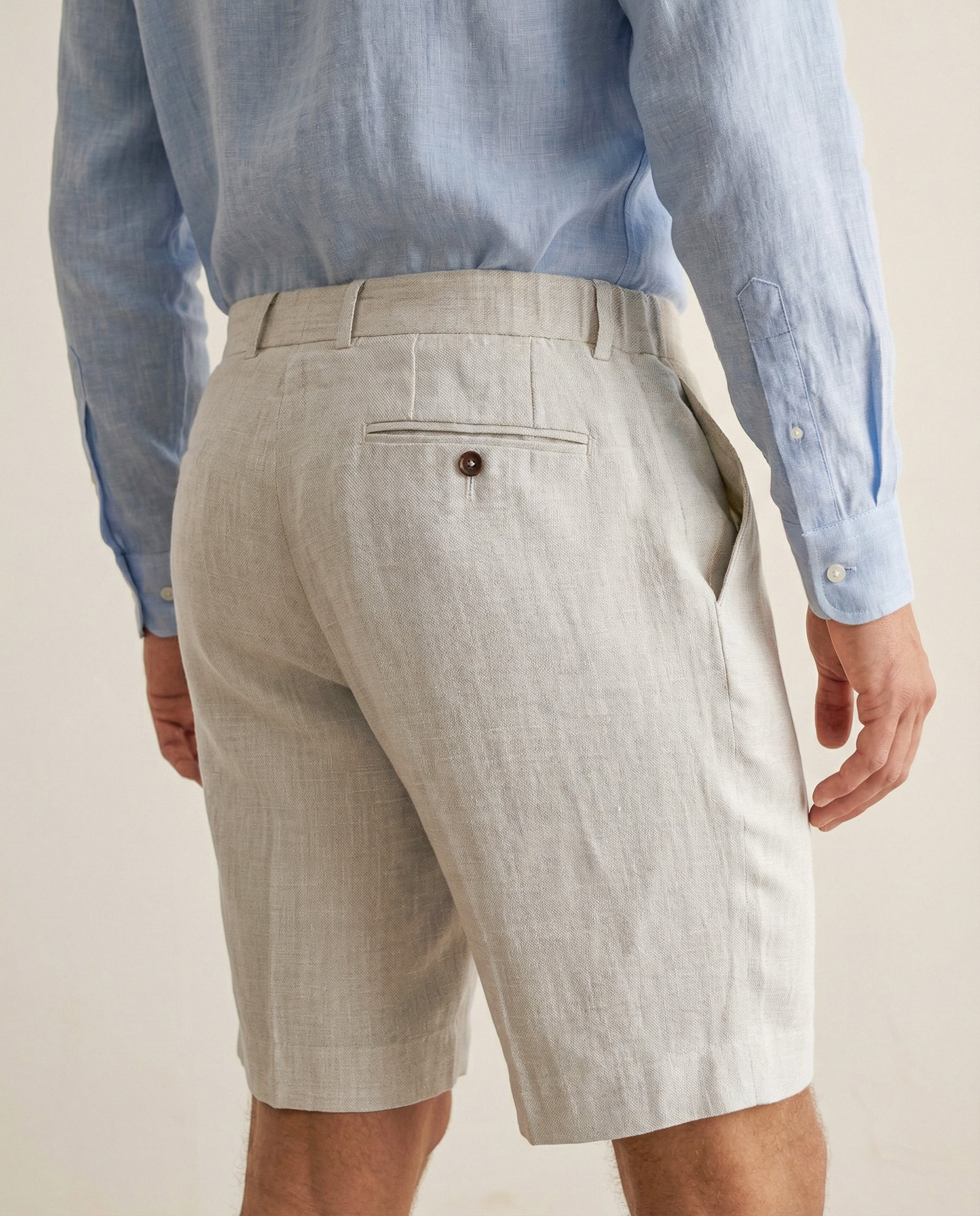 Back view of men’s natural linen shorts with rear pocket