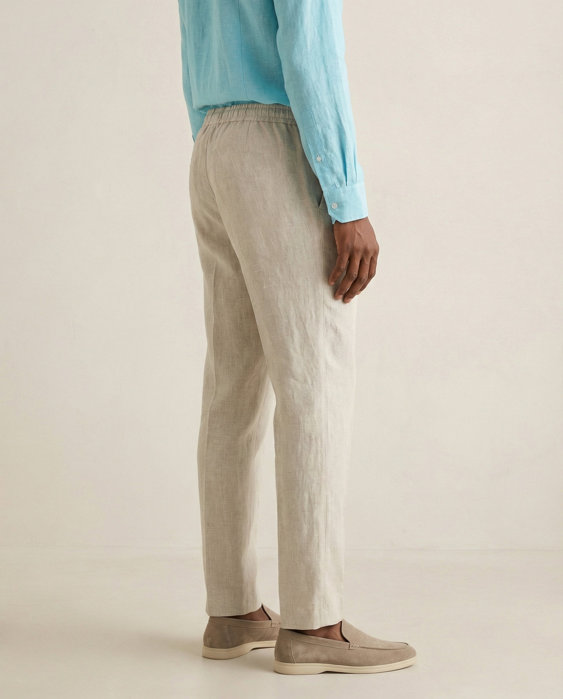 Back view of men’s natural linen trousers with elastic waistband