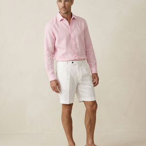 Men’s pearl white linen shorts worn with pink linen shirt, full outfit view
