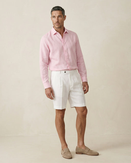 Men’s pearl white linen shorts worn with pink linen shirt, full outfit view
