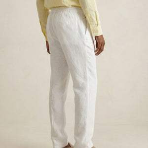 Back view of men’s pearl white linen trousers with elastic waistband