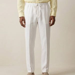Front view of men’s pearl white linen trousers with drawstring waist