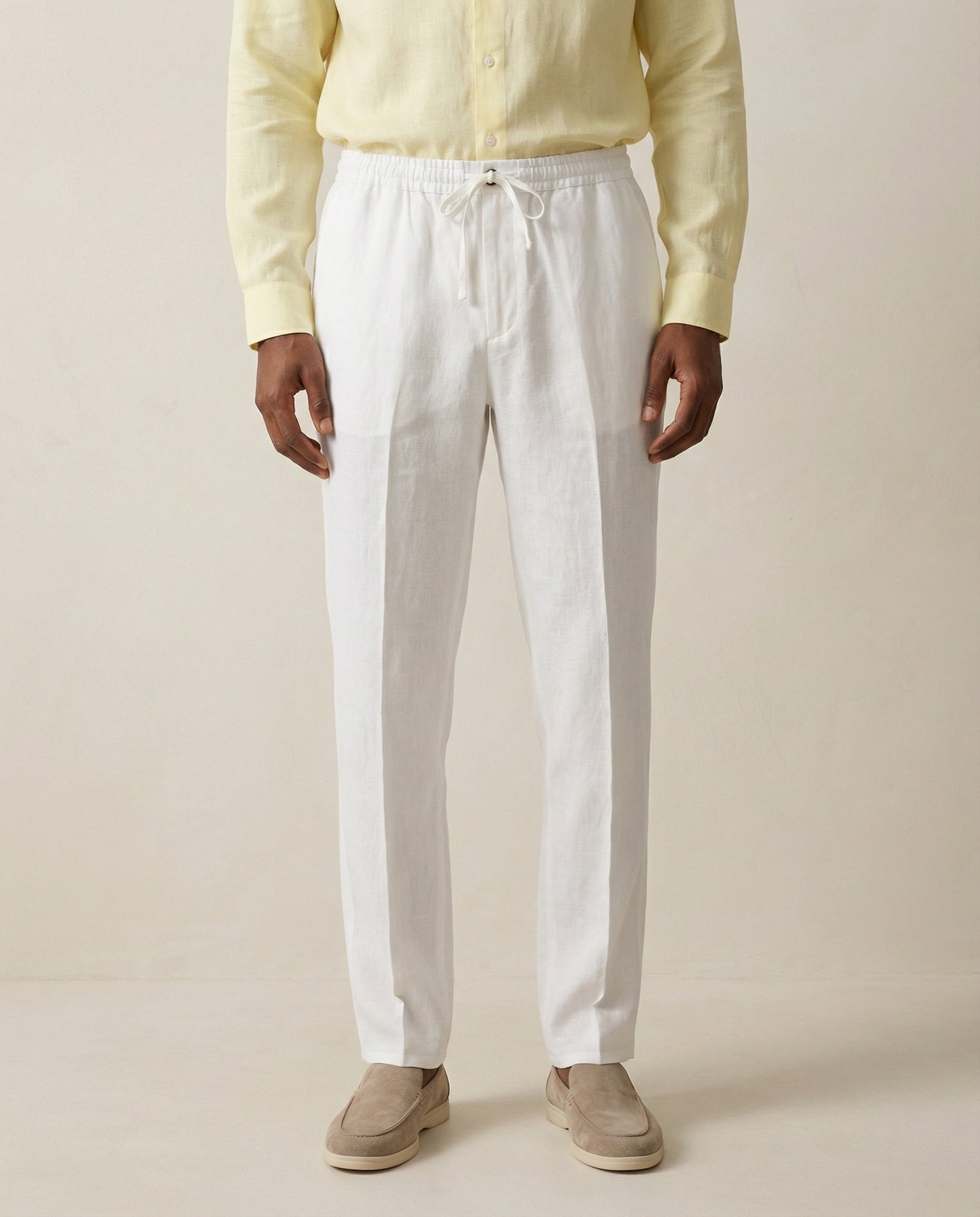 Front view of men’s pearl white linen trousers with drawstring waist