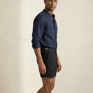 Mid-length view of Riviera black swim shorts showing structured waistband and tailored fit.