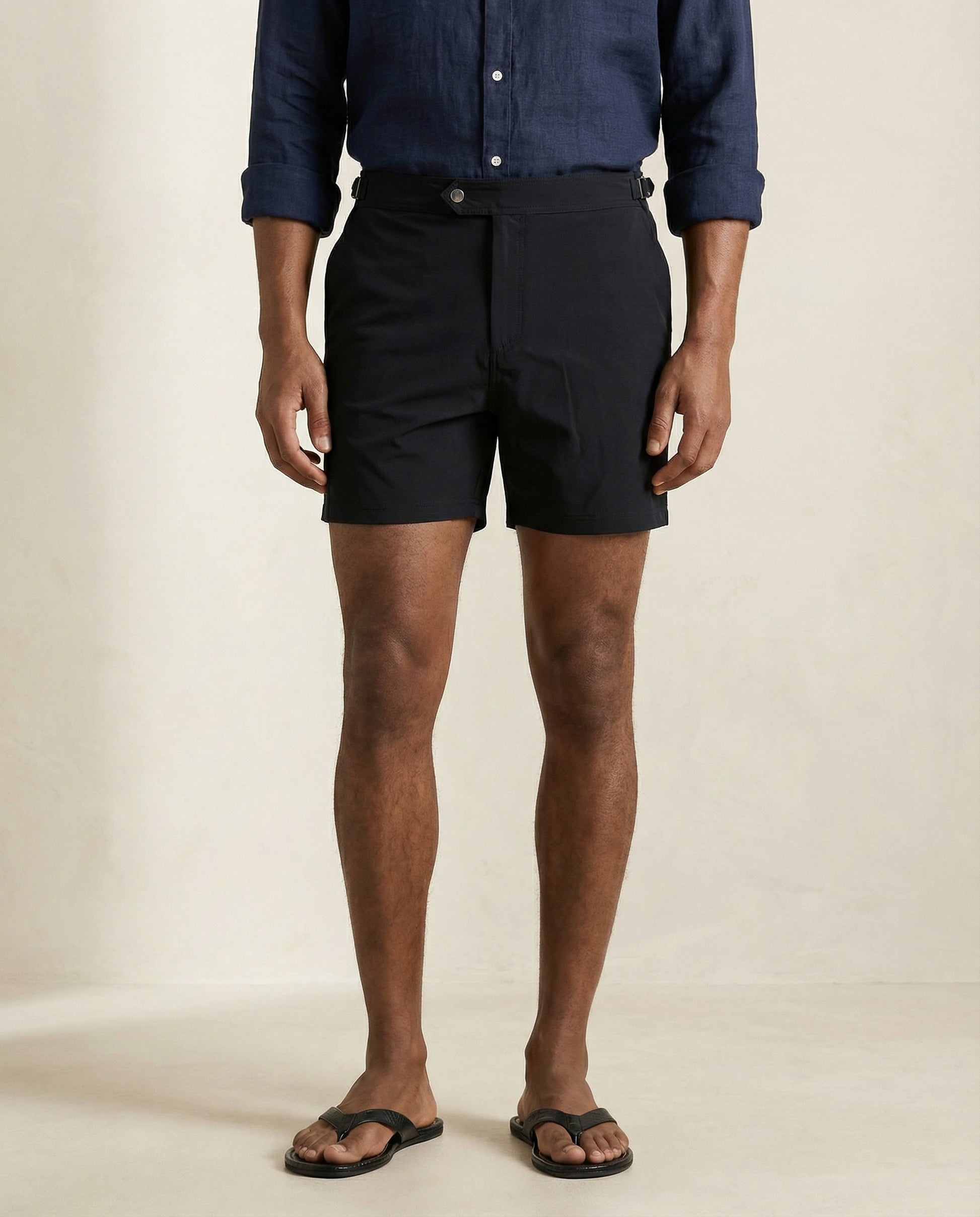 Front product view of Riviera black tailored swim shorts with structured waistband.