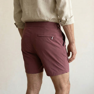 Back view of Riviera burgundy tailored swim shorts with minimalist rear pocket and refined finish.