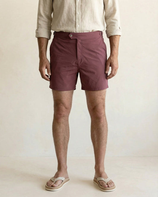 Riviera burgundy side buckle swim shorts in technical stretch fabric, designed for modern resort dressing.
