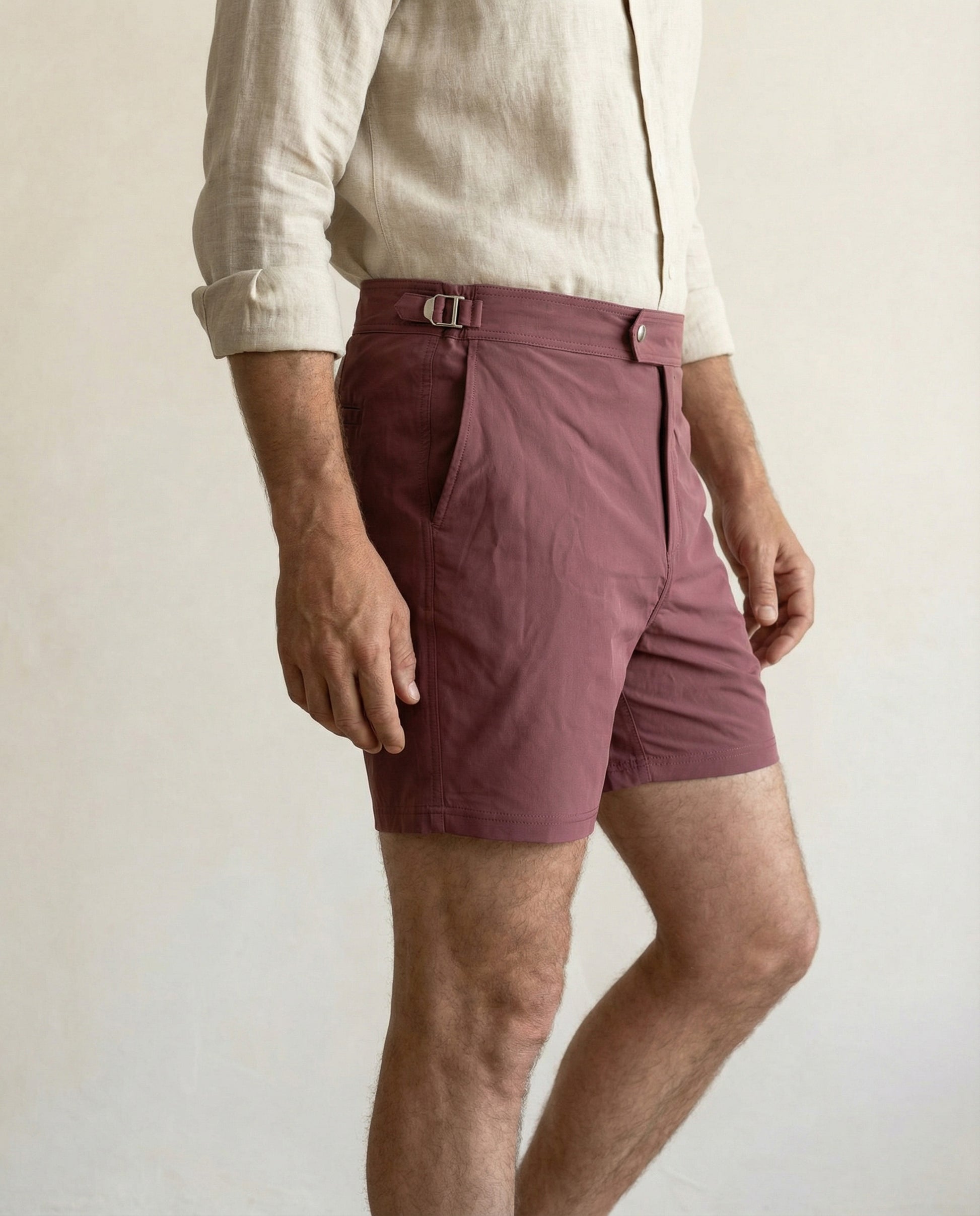 Close-up of Riviera burgundy swim shorts showing adjustable side buckle and clean waistband construction.