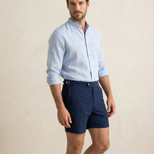 Riviera navy tailored swim shorts with extended waistband and adjustable side buckle detail.