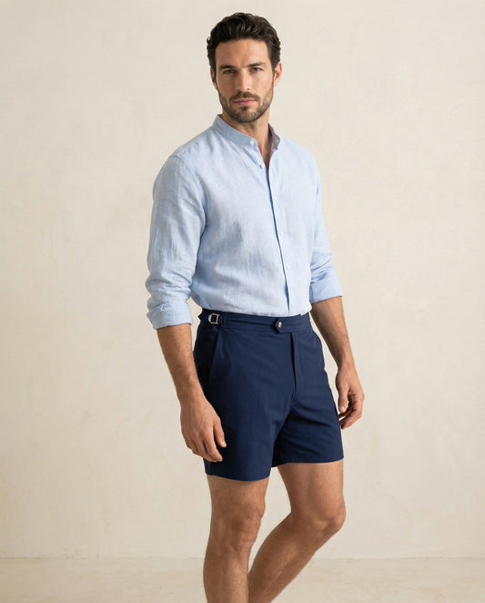 Riviera navy tailored swim shorts with extended waistband and adjustable side buckle detail.
