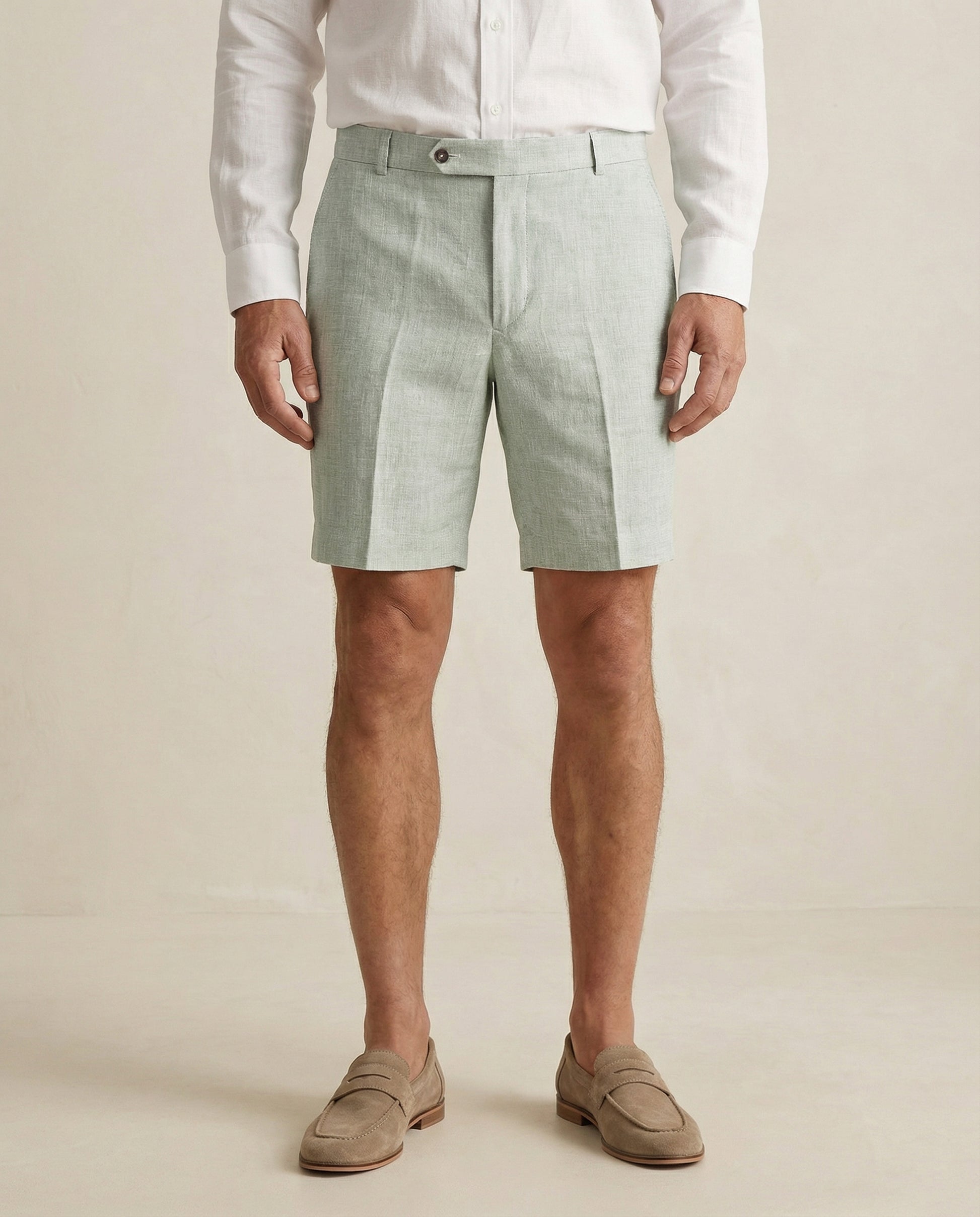 Detail of sage green linen shorts fabric and tailored waistband