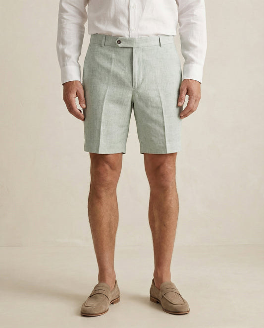 Detail of sage green linen shorts fabric and tailored waistband