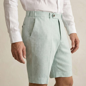 Side view of men’s sage green linen shorts with tailored fit