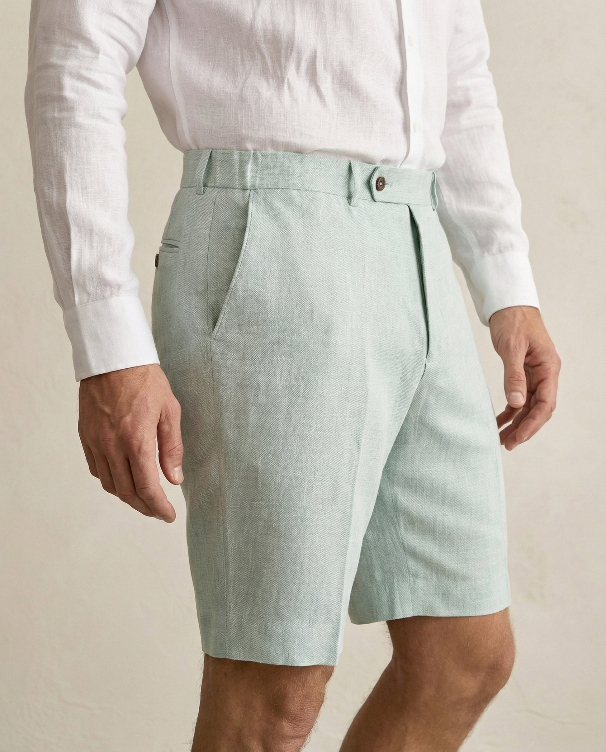Side view of men’s sage green linen shorts with tailored fit