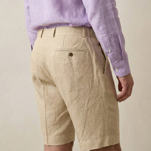 Back view of men’s beige linen shorts with rear pocket