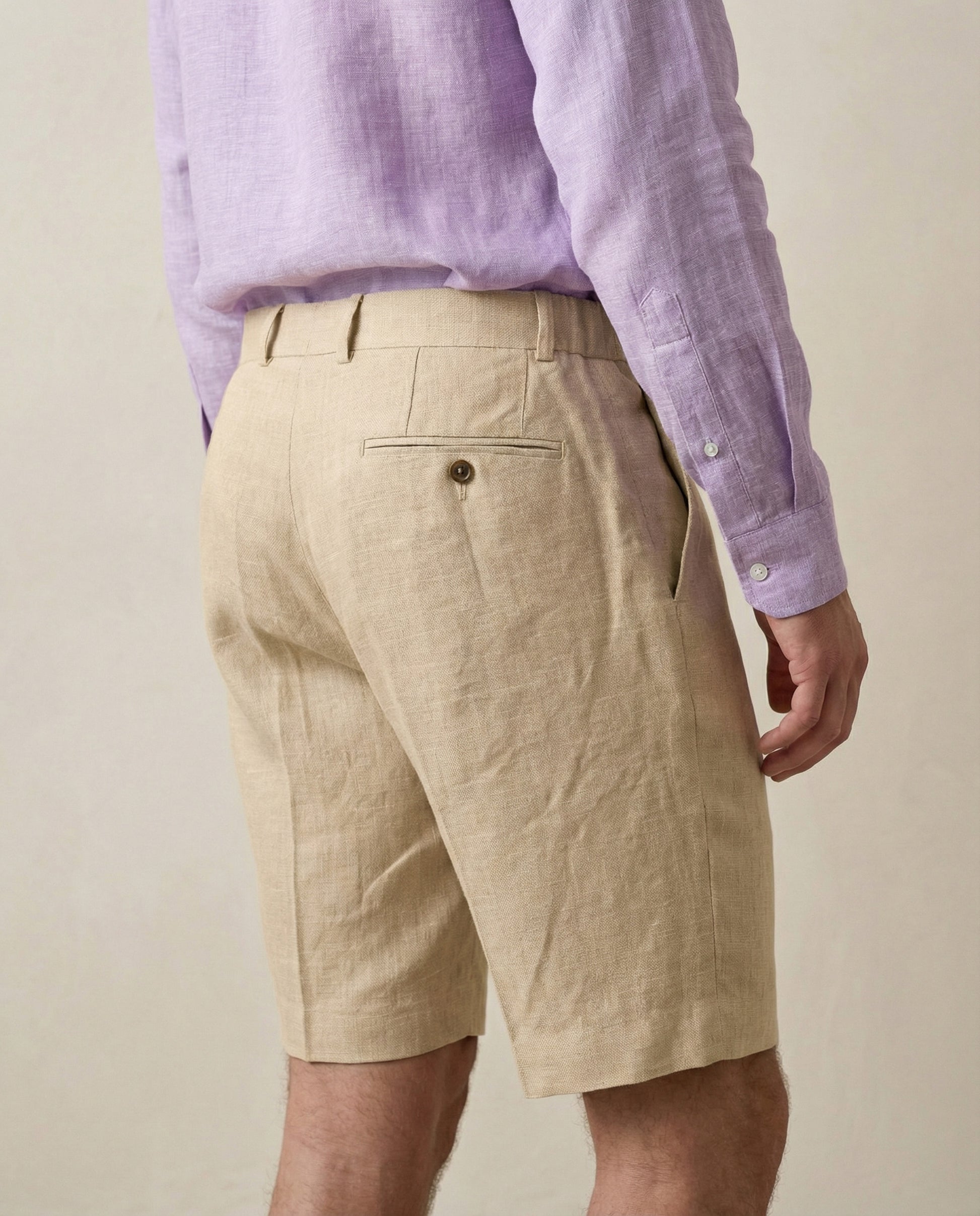 Back view of men’s beige linen shorts with rear pocket