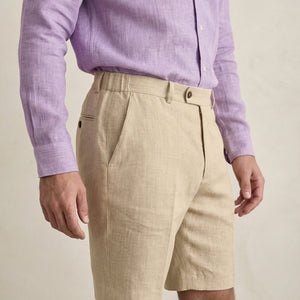 Side view of men’s beige linen shorts showing pocket and tailoring