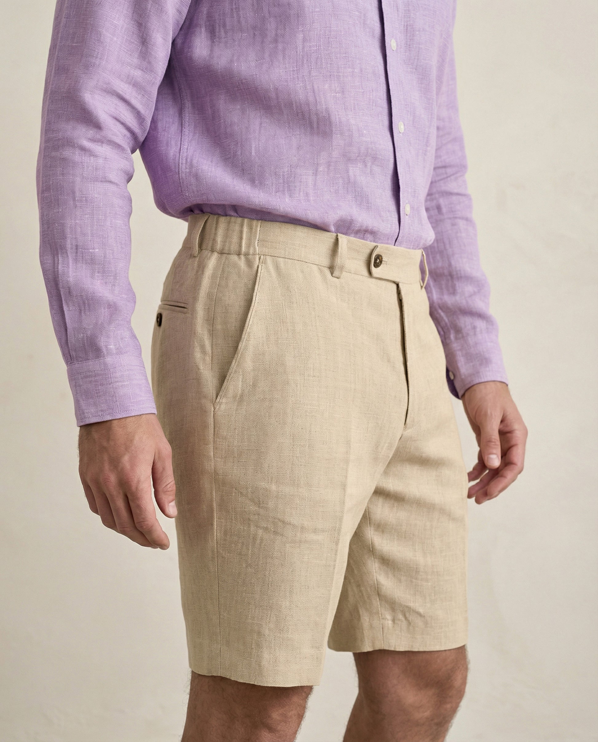 Side view of men’s beige linen shorts showing pocket and tailoring