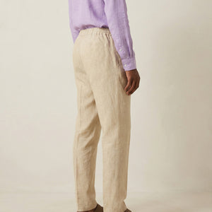 Back view of men’s beige linen trousers with elastic waistband