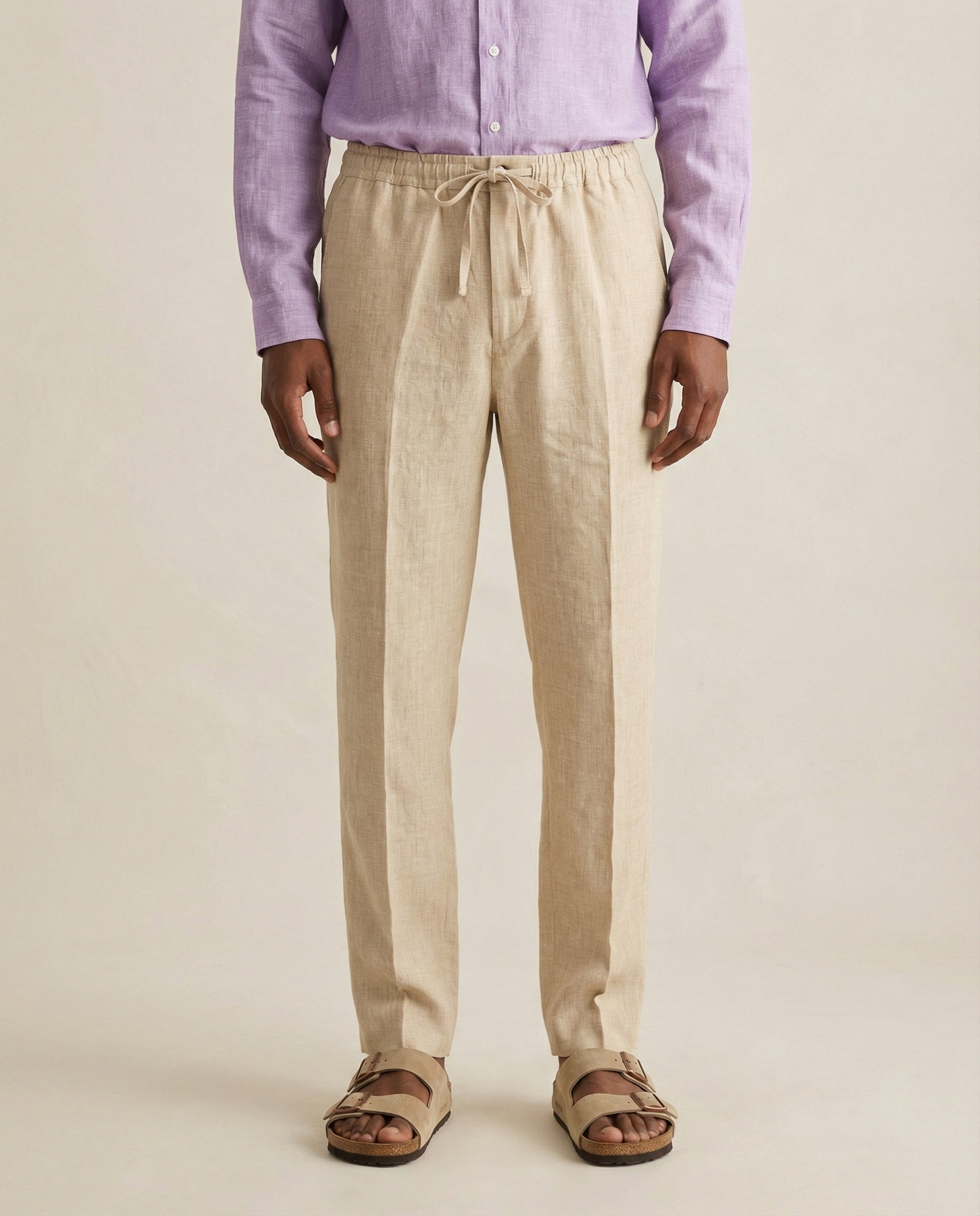 Front view of men’s beige linen trousers with drawstring waist