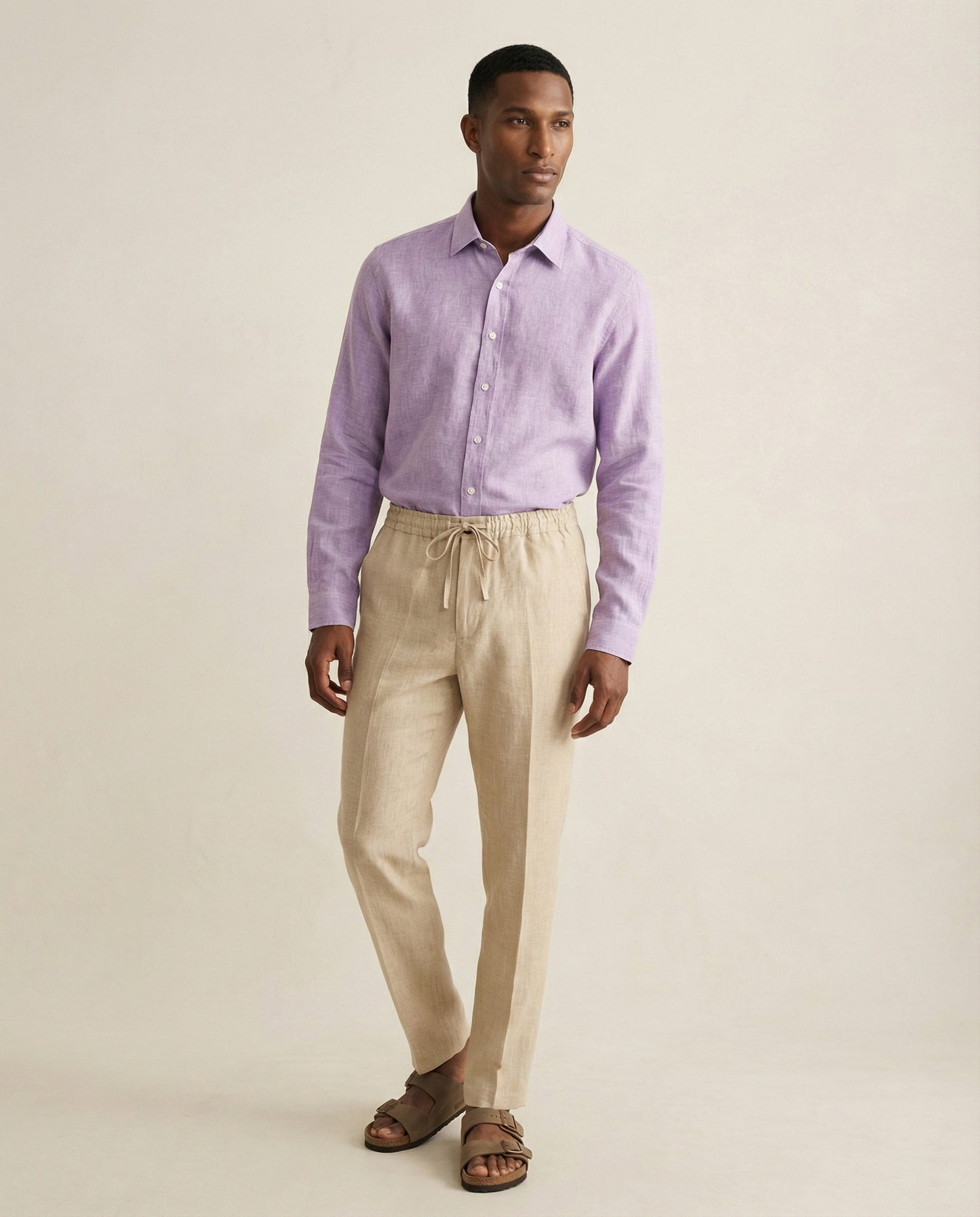 Men’s Senna beige linen trousers worn with lilac linen shirt, full outfit view