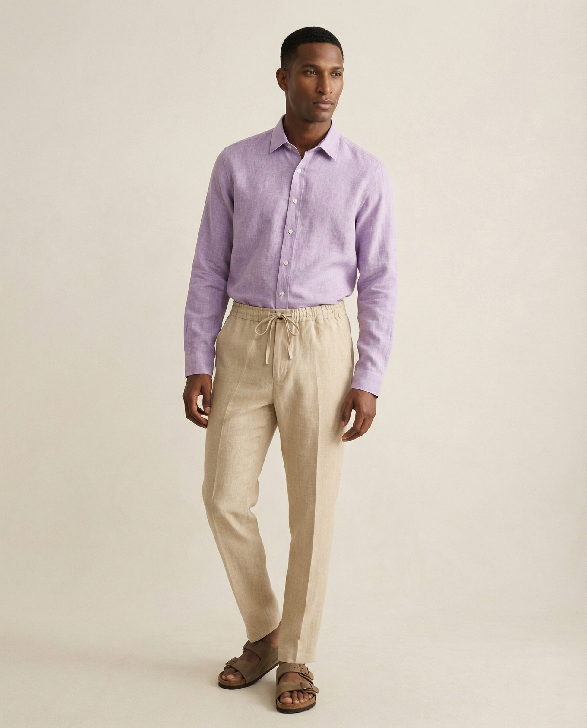 Men’s Senna beige linen trousers worn with lilac linen shirt, full outfit view