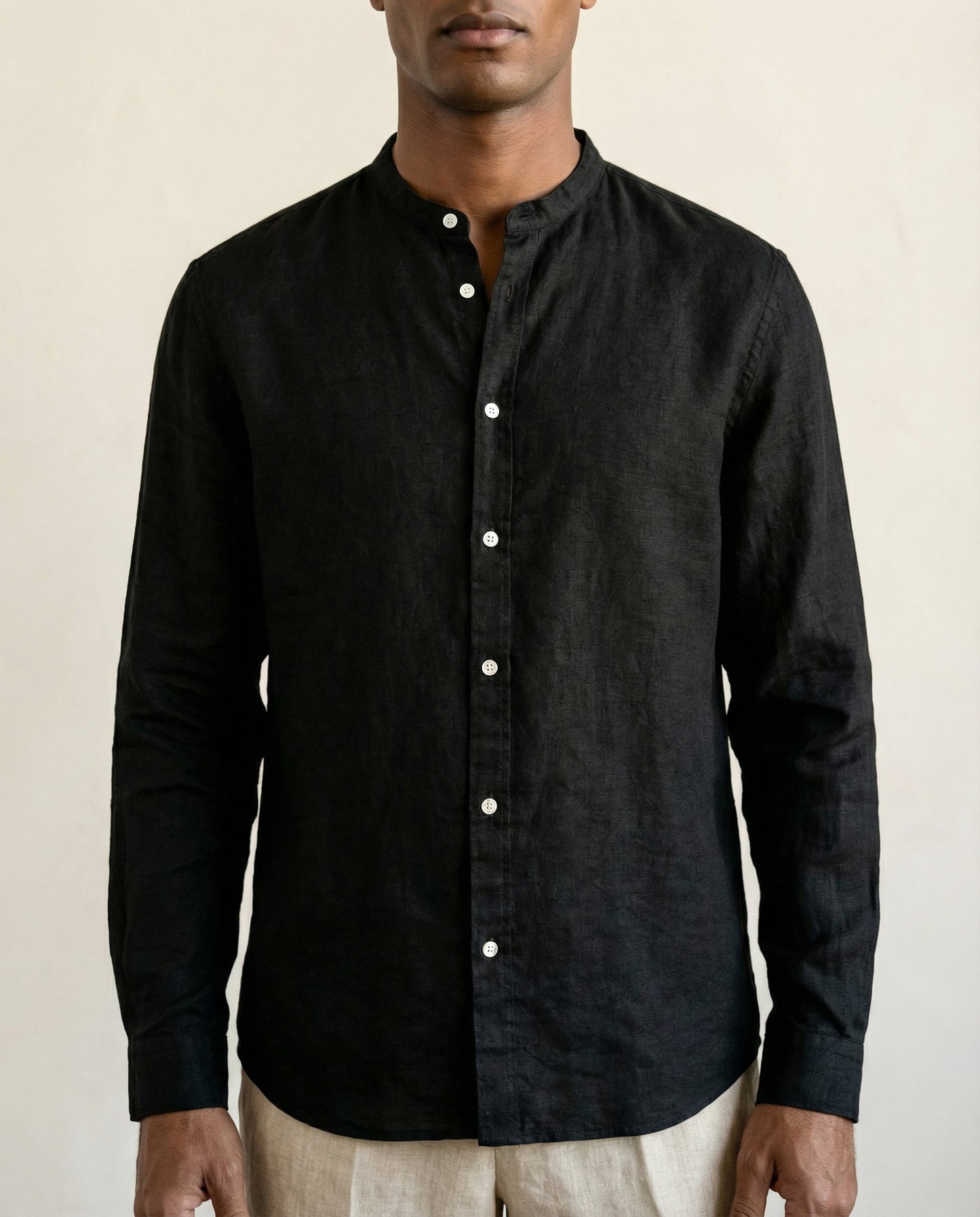 Detail of black linen shirt with Chinese collar and white buttons